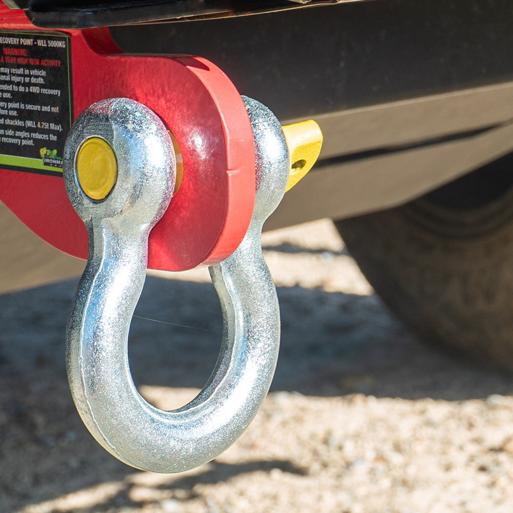Bow shackle with yellow pin secured to 4WD rear recovery point.