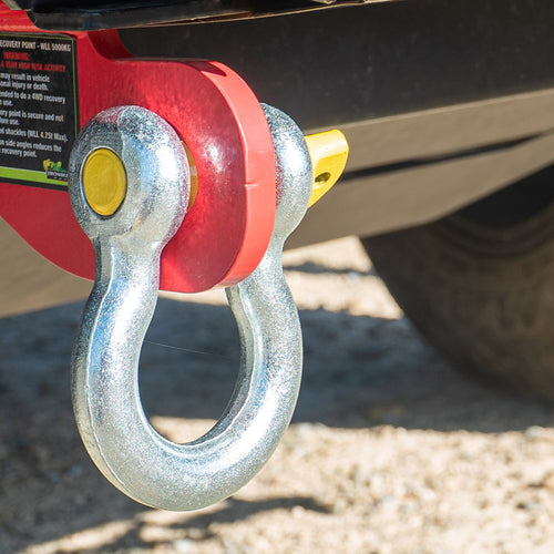 Bow shackle with yellow pin secured to 4WD rear recovery point.