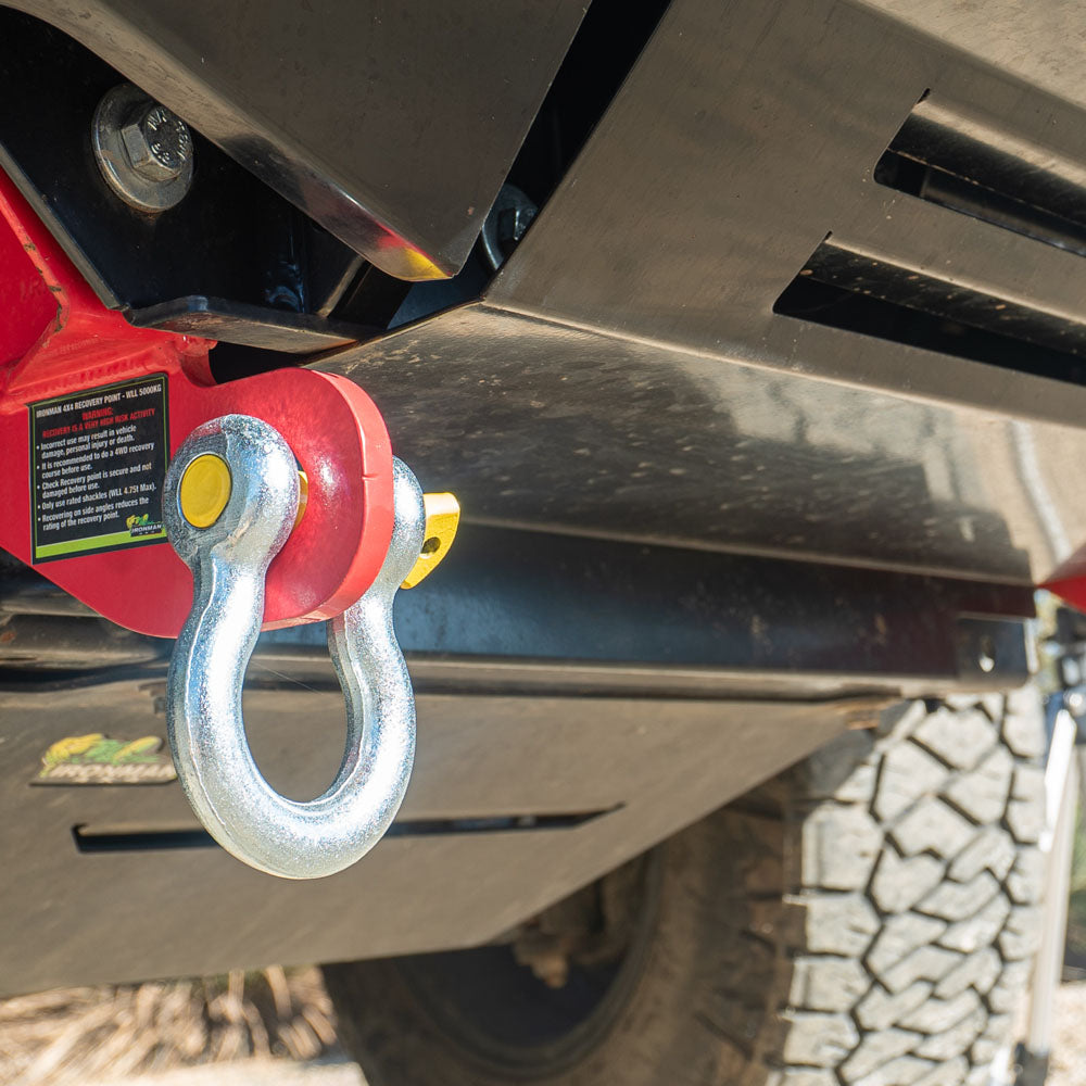 Bow shackle with yellow pin secured to 4WD rear recovery point.