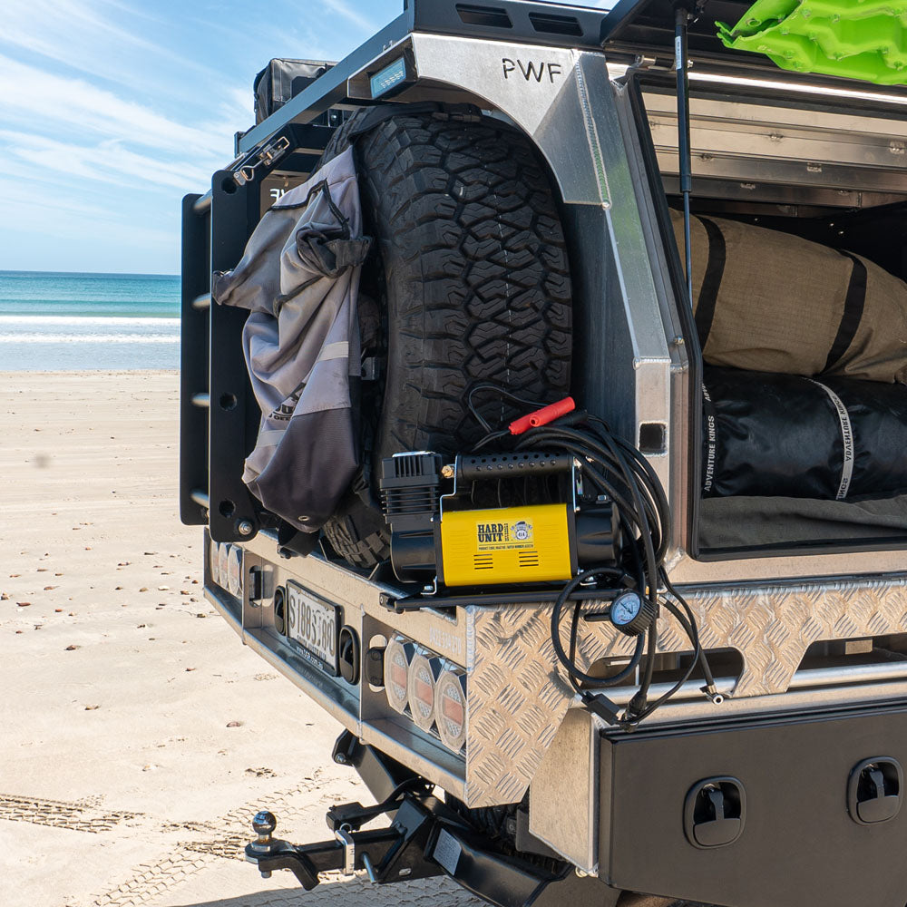 12V air compressor put on 4WD at the beach, with gauge and alligator clips for off-road tyre inflation.