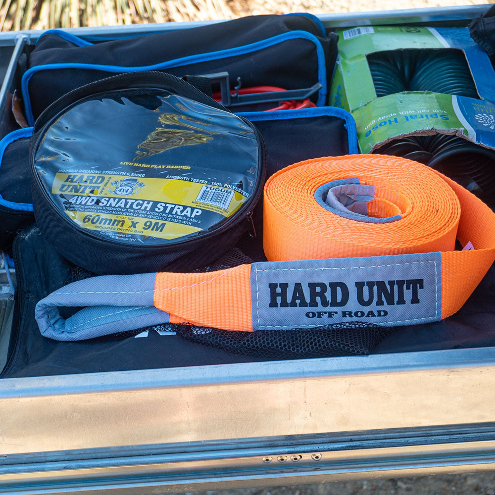 Orange 4WD snatch strap with protective sleeve and carry bag, 60mm x 9m recovery strap packed in vehicle drawer system.
