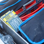 Box of Hard Unit tyre repair strings stored in a vehicle drawer system alongside jumper cables and tool bags.